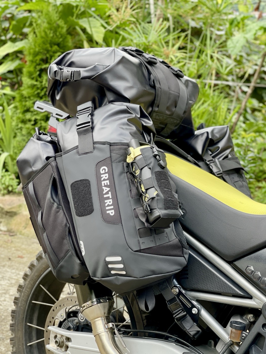 Black and yellow flask attached to the MOLLE panel on a GREATRIP outer side pocket